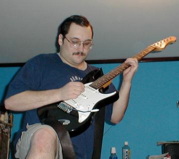 Ken playing the guitar